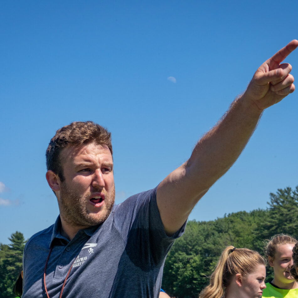 A PBRC Staff Member pointing players in a direction